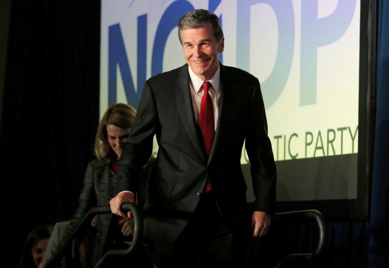 Image: Roy Cooper, North Carolina candidate for governor, smiles as he walks on stage during an election night party in Raleigh