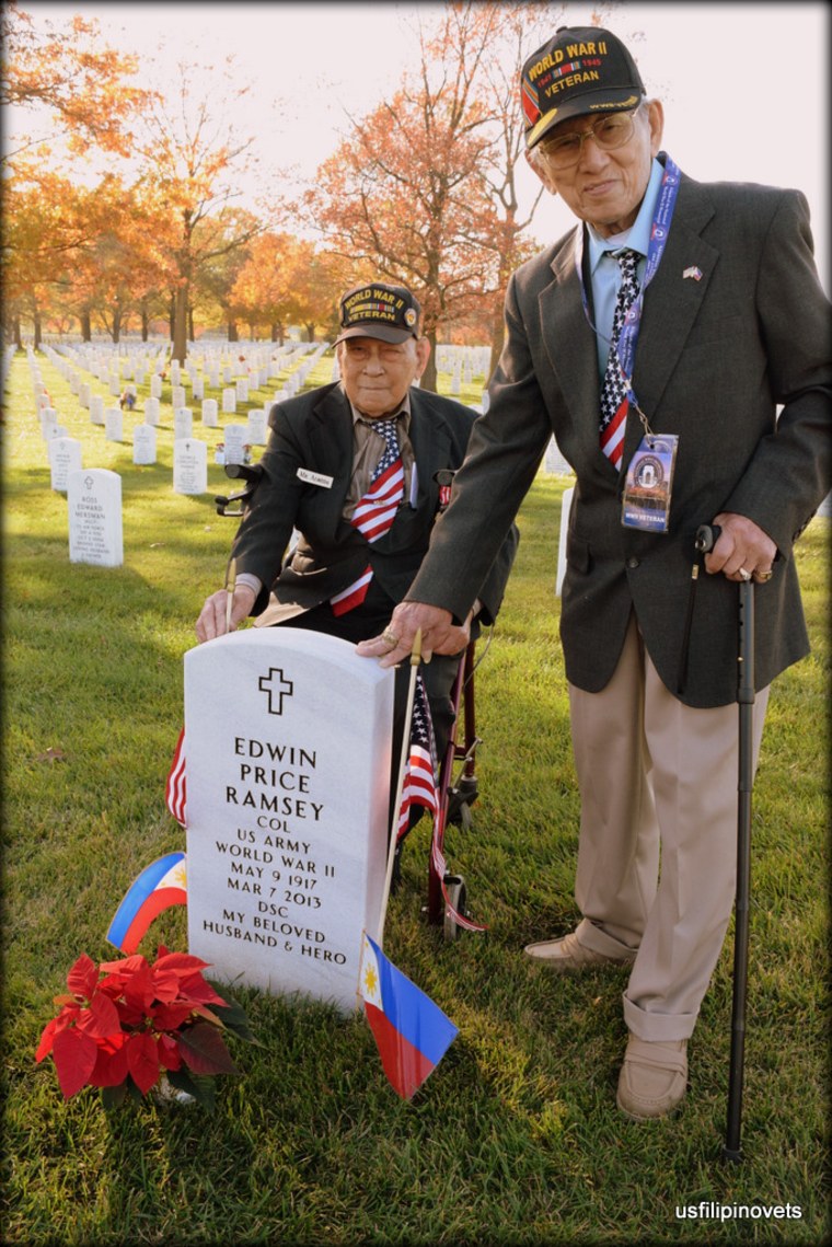 Celestino Almeda and fellow veteran Pontenciano Dee stand behind headstone of Col. Edwin Ramsey, who led 24,000 Filipino guerrillas in Central Luzon in WWII.