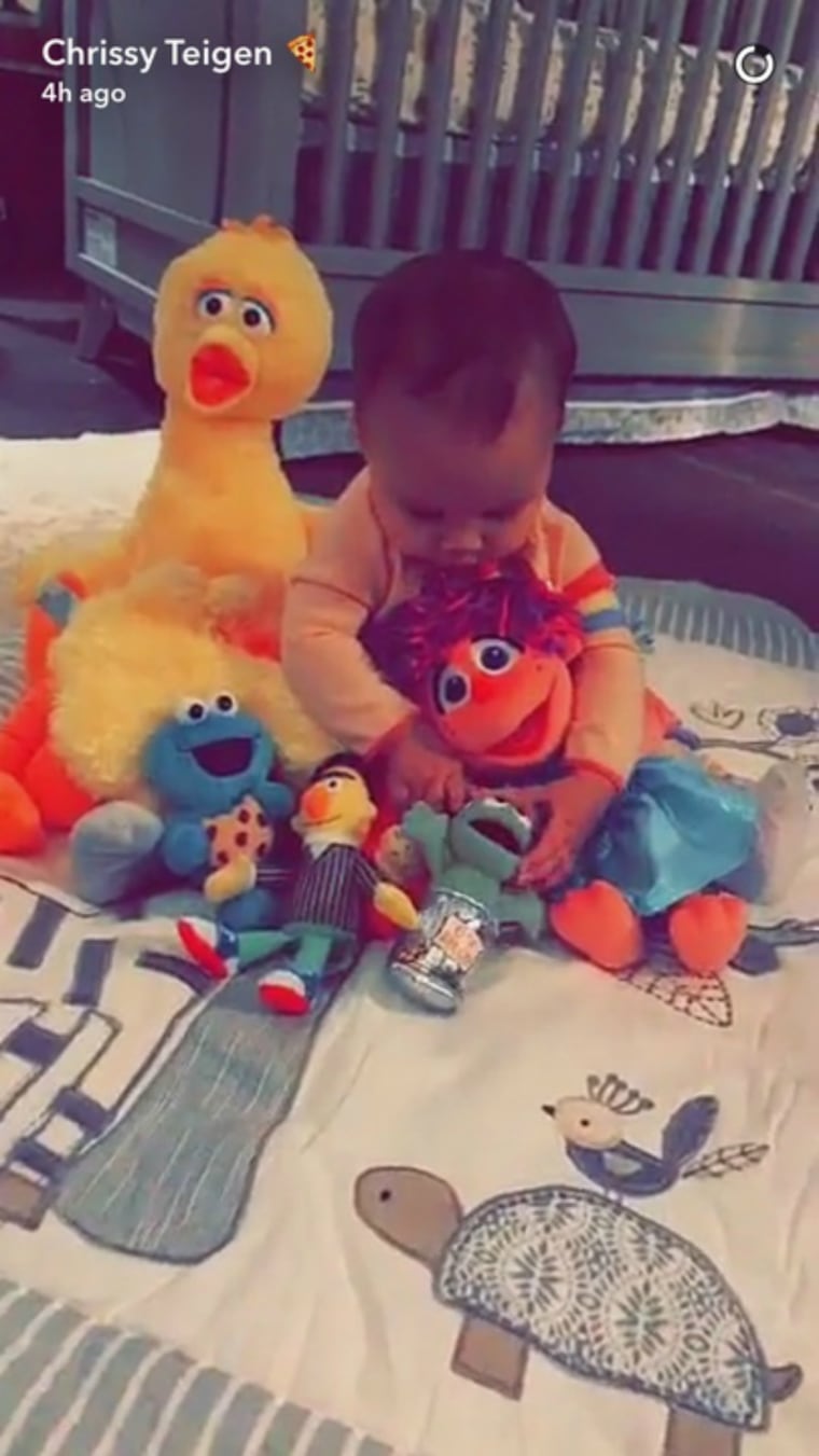 Chrissy Teigen Snapchat of baby Luna with 'Sesame Street' dolls
