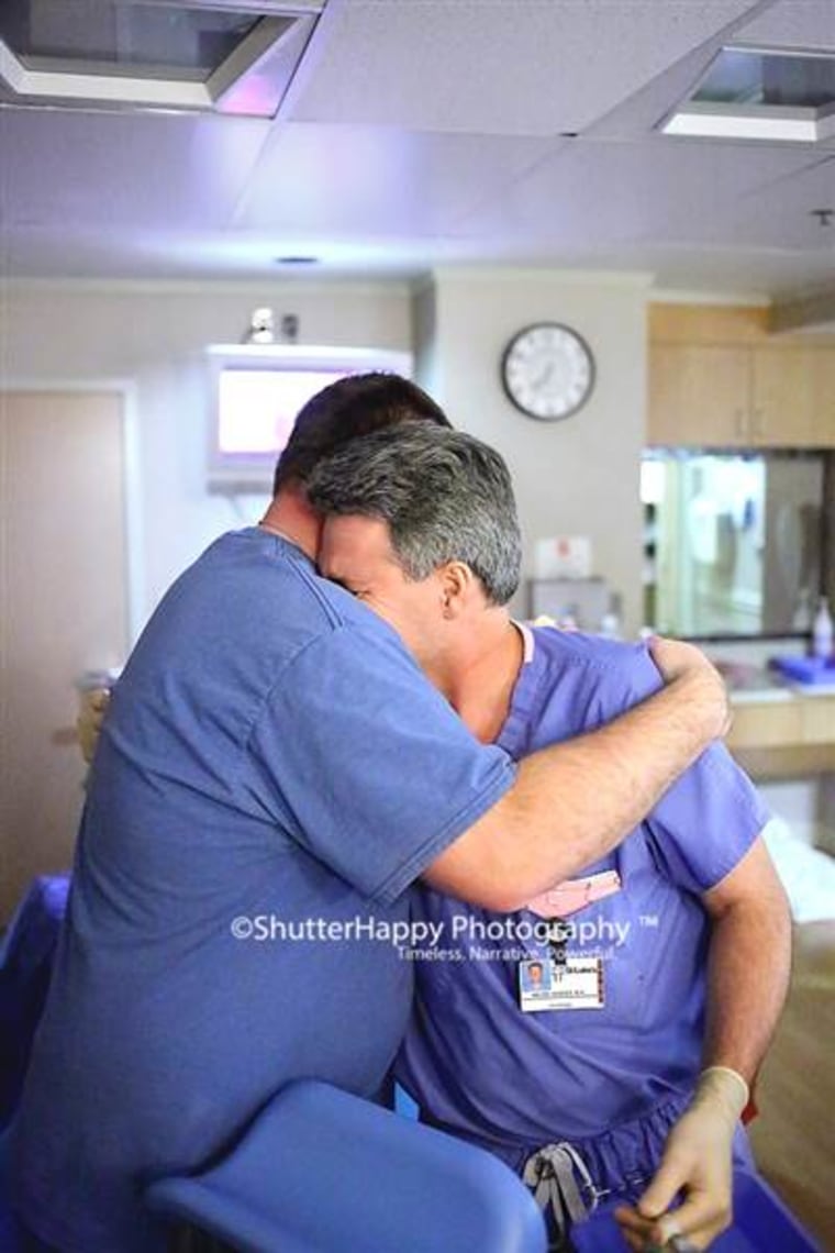 Andrew Hanson, left, hugs Dr. Bryan Hodges after he delivered his son Karson at St. Luke's Hospital in Boise, Idaho. Hanson's first baby died soon after birth less than a year earlier.