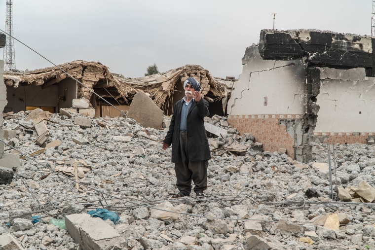 Image: Hamid Zorab, 73, stands on a pile of rubble that was once his living room.