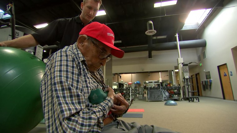 Pearl Harbor survivor Ray Chavez working out with his trainer