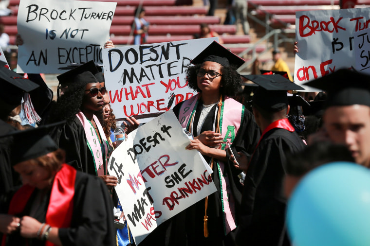 Image: Protesters hold signs to raise awareness of sexual assault at Stanford University