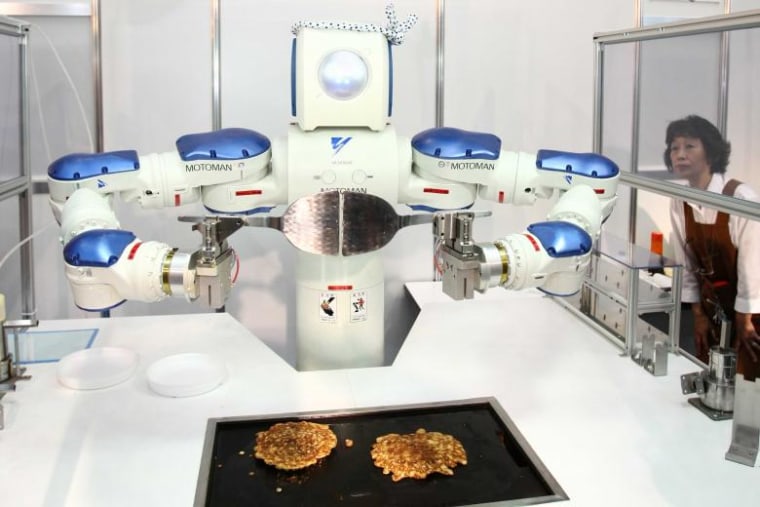A cooking robot turns over okonomiyaki (Japanese flour cake) during the International Food Machinery and Technology exhibition in Tokyo. Reuters | Hitoshi Yamada