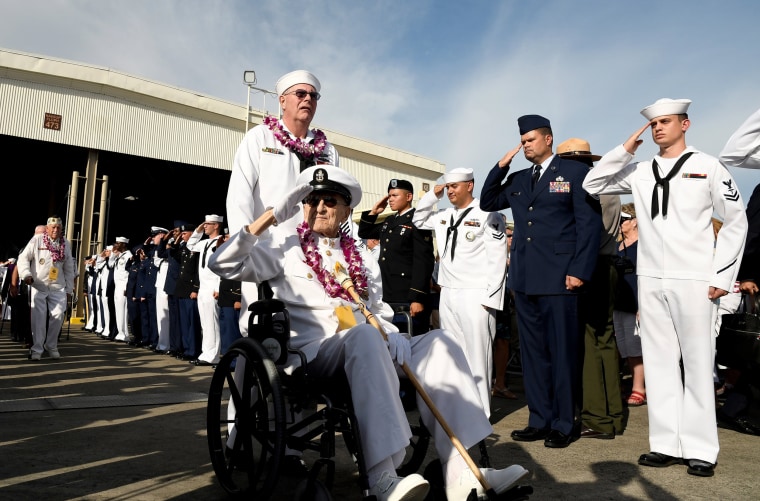 Image: Pearl Harbor survivor Robert Coles salutes active U.S. service members after the ceremonies honoring the 75th anniversary of the attack on Pearl Harbor at Kilo Pier on Joint Base Pearl Harbor - Hickam in Honolulu