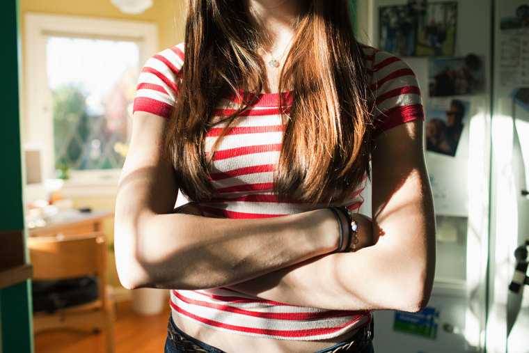 Teenage girl with arms crossed
