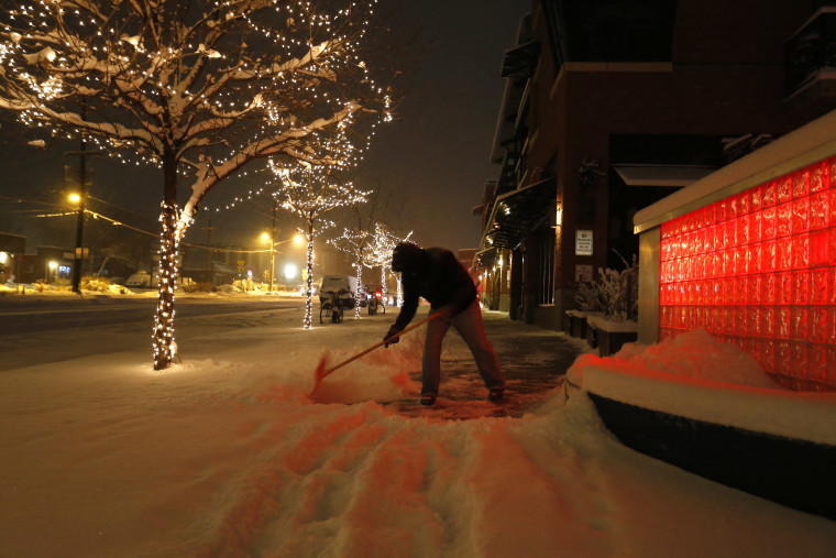 Image: Rick Velasquez shovels fresh snow during a winter storm in Boulder