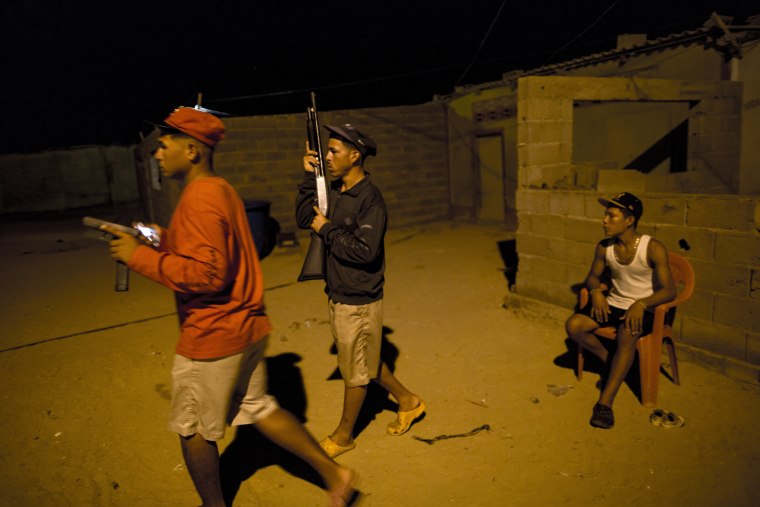 Members of the Marval family, who patrol at night while other members of their family fish at sea, respond to what appeared to be the start of an attack by pirate gang leader "El Beta" in Punta de Araya, Sucre state, Venezuela.