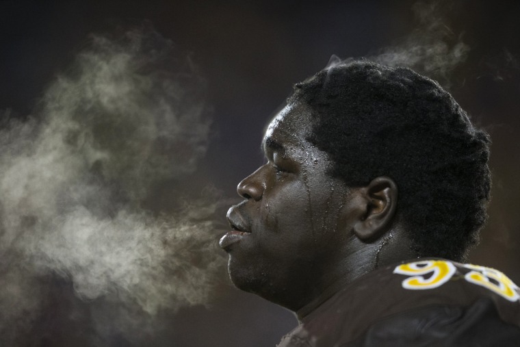 Image: Steam rises from Wyoming's Youhanna Ghaifan during an NCAA college football game against San Diego State