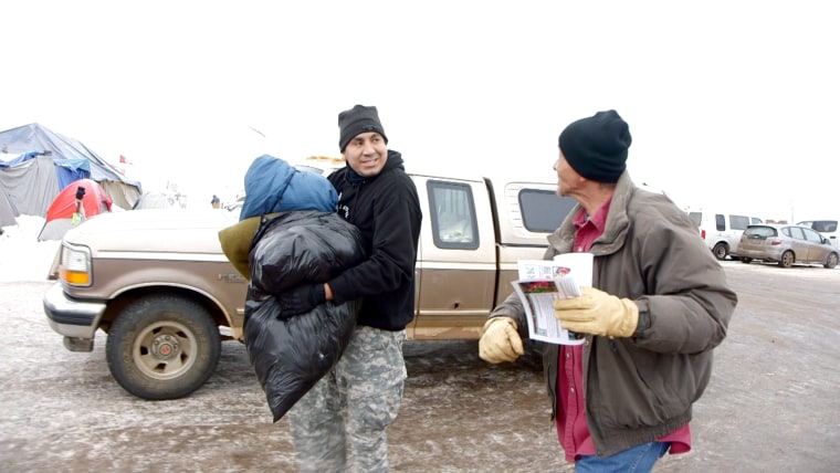 Dustin Monroe carries clothing donations for the Oceti Sakowin camp.