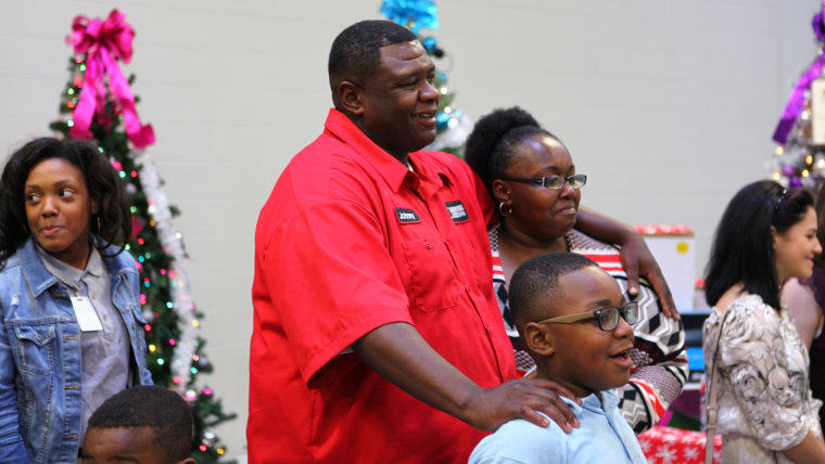 Johnny Herman stands with his family