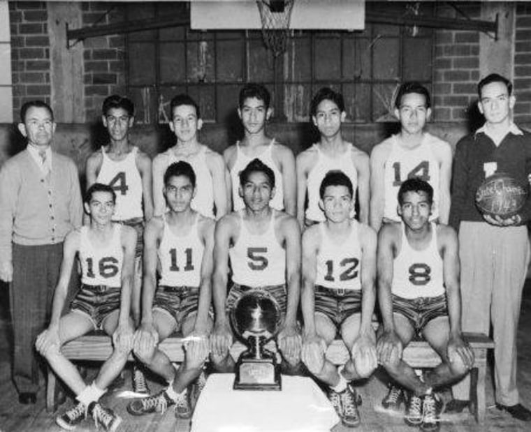 The Lanier High School Voks basketball team with their 1939 San Antonio Championship trophy.