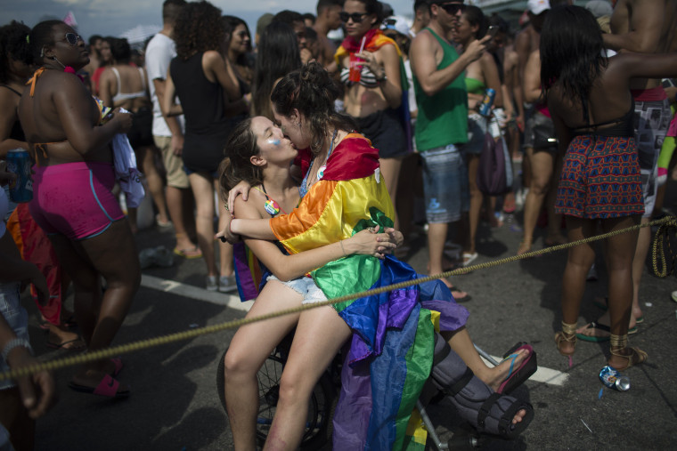 Image: Revelers take part in the 21st Rio LGBT pride parade at Copacabana beach in Rio de Janeiro