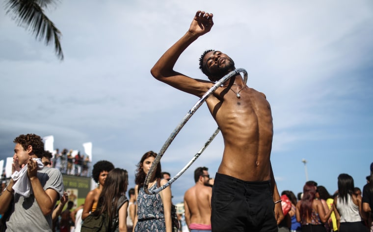Image: Revelers take part in the 21st Rio LGBT pride parade at Copacabana beach in Rio de Janeiro