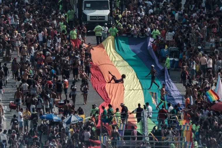 Image: Revelers take part in the 21st Rio LGBT pride parade at Copacabana beach in Rio de Janeiro