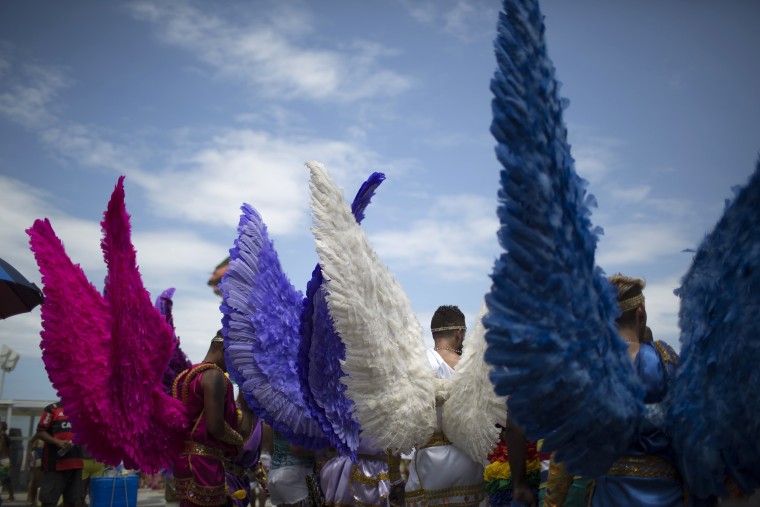 Image: Revelers take part in the 21st Rio LGBT pride parade at Copacabana beach in Rio de Janeiro
