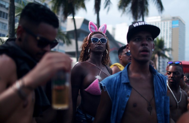 Image: Revelers take part in the 21st Rio LGBT pride parade at Copacabana beach in Rio de Janeiro