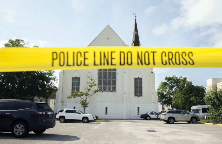 Image: Police tape surrounds the parking lot behind the AME Emanuel Church