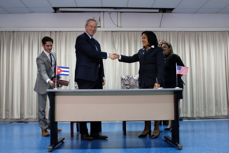 Eric Schmidt, chairman of Alphabet Inc. (L) and Mayra Arevich Marin, president of state telecommunications monopoly ETECSA, shake hands after signing documents in Havana, Cuba