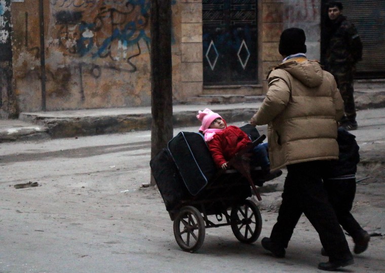 Image: Civilians flee the Sukkari neighborhood towards safer areas in southeastern Aleppo, Monday.