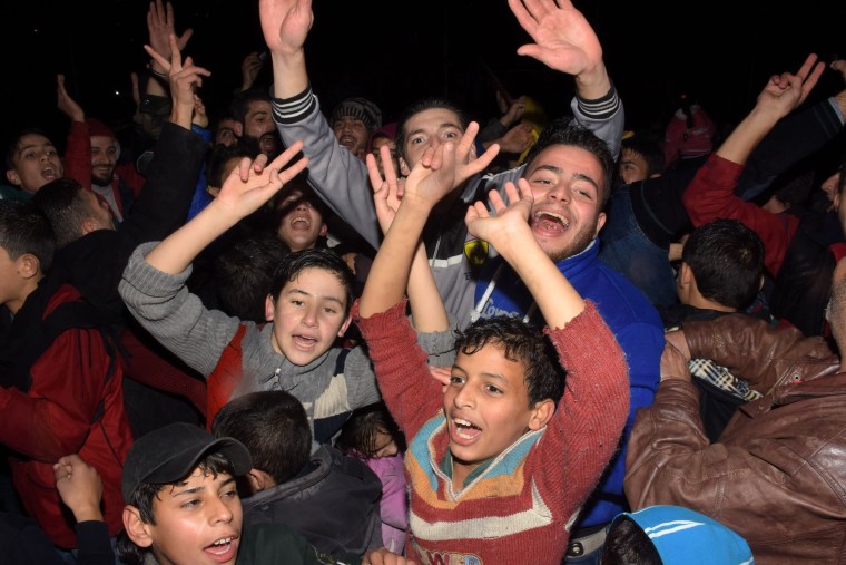 Image: Civilians celebrate in the government-held Mogambo neighborhood of Aleppo after pro-Assad forces won more territory in the city.