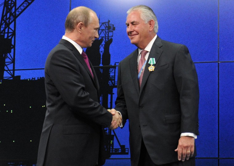 Image: Russian President Vladimir Putin presents ExxonMobil CEO Rex Tillerson with a Russian medal at an award ceremony