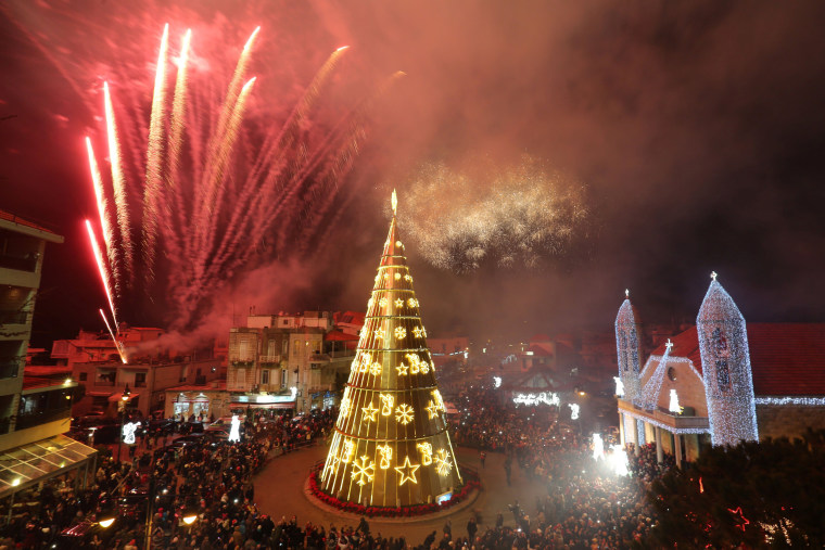 Image: Fireworks are set off as a Christmas tree is illuminated in Dhour Shweir, Mount Lebanon