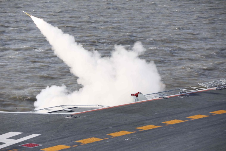 Image: A missile being fired from the Liaoning aircraft carrier during military drills in the Bohai Sea