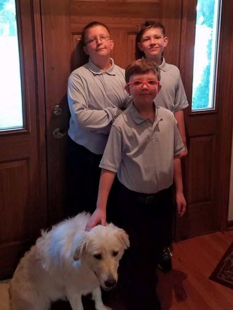 Ryan with his brothers, Zachary, 12, and Matthew, 11, and their dog, Nix.