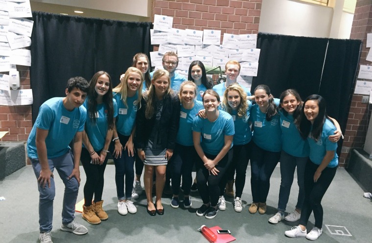 Prout poses with students at Georgetown Day School, which hosted the Washington Area Independent School Summit on Sexual Assault and Consent. Prout spoke at the event, along with other teenage survivors.