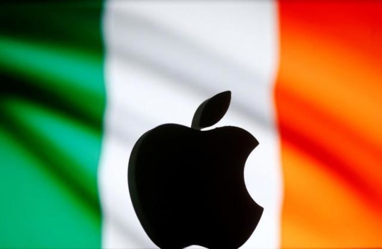 A 3D printed Apple logo is seen in front of a displayed Irish flag in this illustration