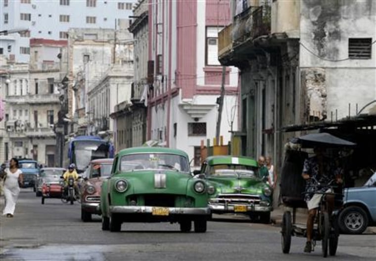 Cars drive on a street in Havana