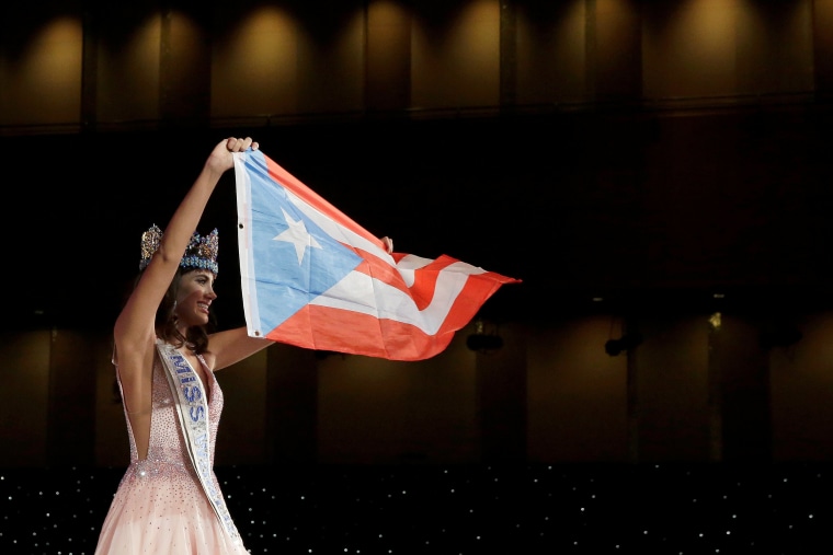 Miss Puerto Rico Stephanie Del Valle holds up the Puerto Rican flag after winning the Miss World 2016 Competition in Oxen Hill, Maryland.