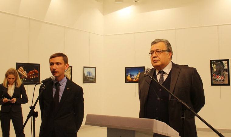 Image: Russian Ambassador to Turkey, Andrei Karlov (R) gives a speech