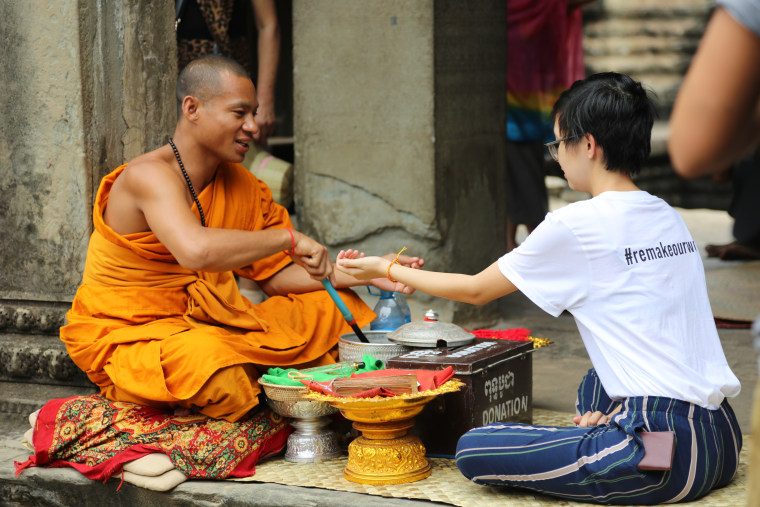 Anh Le with a monk at Angkor Wat in Cambodia.