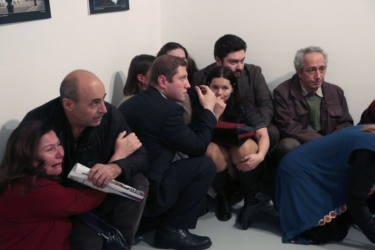 Image: People crouch in corner after Andrei Karlov killing