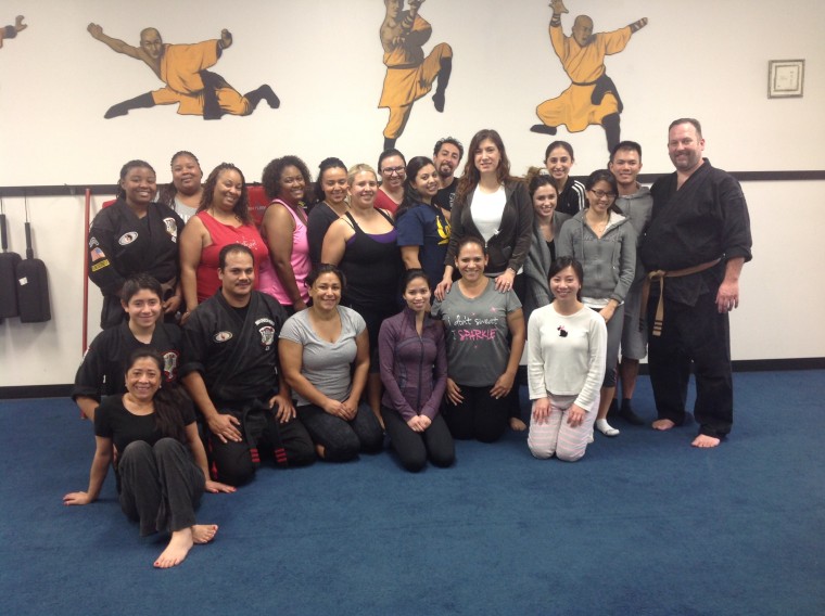 Owner of MG Kenpo Academy Maurice Gomez (bottom row, left) with a group of women enrolled in one of his self-defense workshops in Duarte, California.