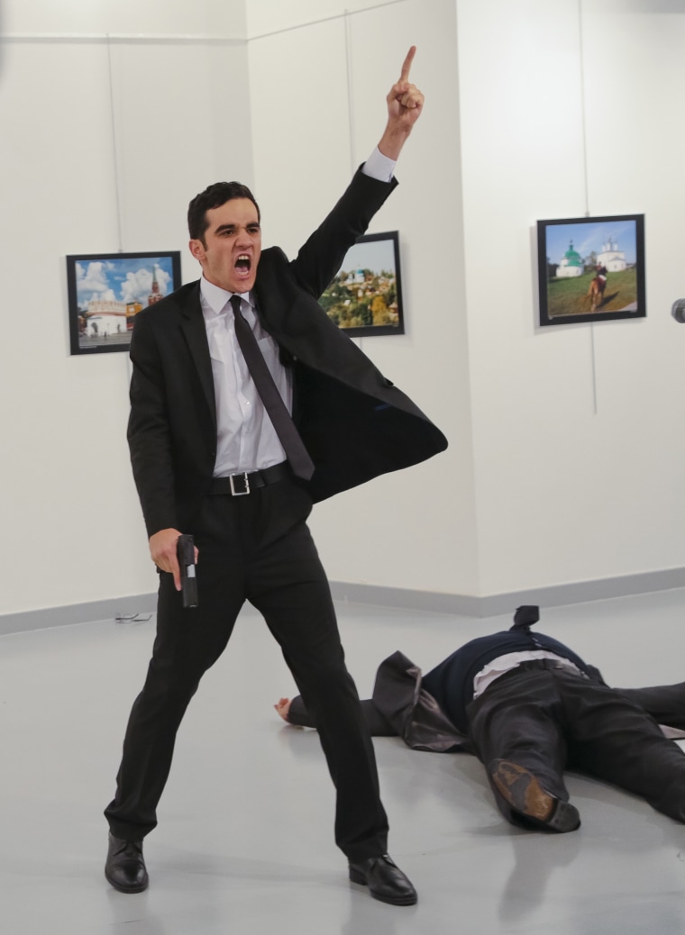 Image: An unnamed gunman gestures after shooting the Russian Ambassador to Turkey, Andrei Karlov, at a photo gallery in Ankara, Turkey, Dec. 19, 2016.