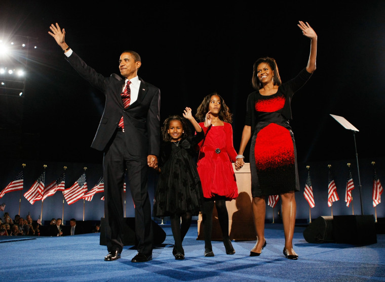 Image: President elect Barack Obama stands on stage along with his wife Michelle and daughters Malia (red dress) and Sasha  (black dress) during an election night gathering in Grant Park on Nov. 4, 2008 in Chicago, Ill.