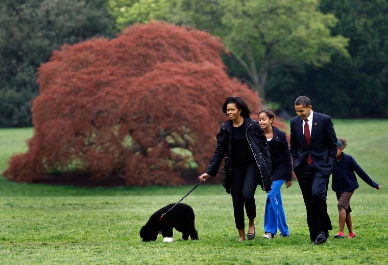 Image: President Barack Obama (2R), First Lady Michelle (L) and their daughters, Sasha (2nd L) and Malia (L), introduce their new dog, a Portuguese water dog named Bo, to the White House press corps at the South Lawn of the White House April 14, 2009.