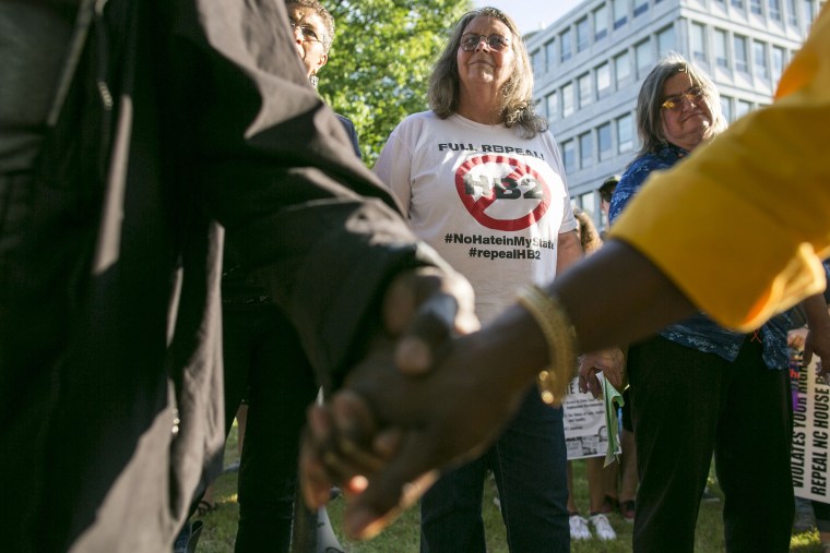 Image: Protestors gather across the street from the North Carolina state legislative building as they voice their concerns over House Bill 2, in Raleigh, N.C., May 16, 2016.