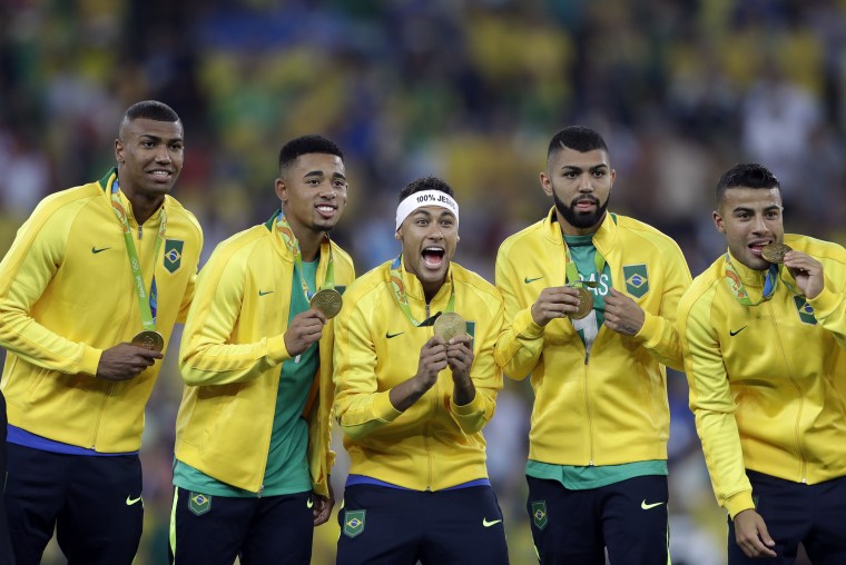 Brazil's Neymar, center, Gabriel Jesus, second from left, Gabriel Barbosa and Rafael Alcantara right celebrate after receiving their gold medals in men's Olympic soccer at the Maracana stadium in Rio de Janeiro on Aug. 20, 2016. Brazil won the gold medal in a penalty shoot-out against Germany.