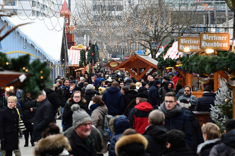 Image: People walk between booths at the Christmas market near the Kaiser-Wilhelm-Gedaechtniskirche (Kaiser Wilhelm Memorial Church) in Berlin on Dec. 22, 2016.