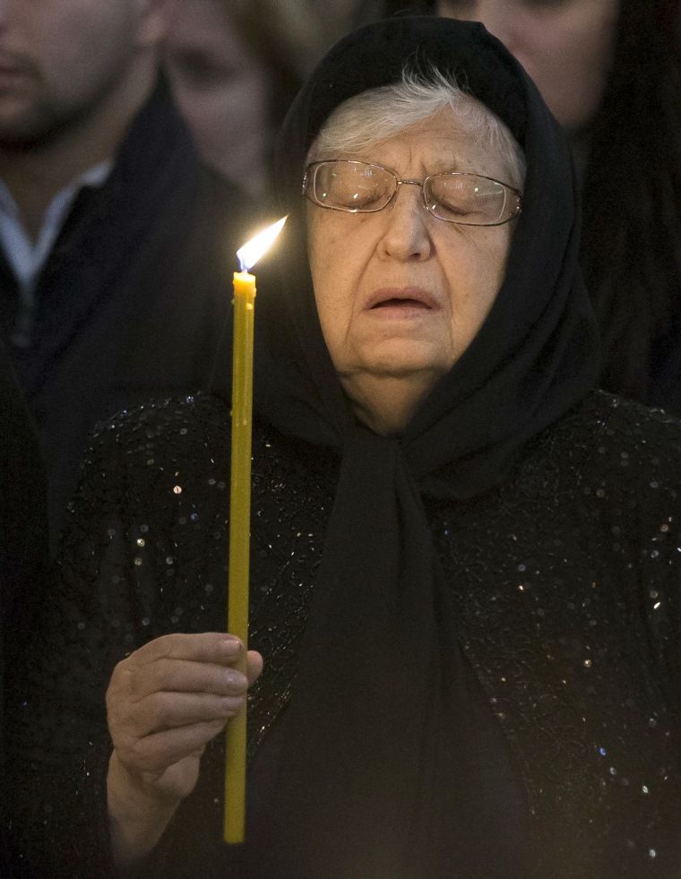 Image: Mother of Andrei Karlov, Maria, mourns holding a candle during a religious service for killed Russian ambassador to Turkey, Andrei Karlov inside the Christ the Saviour Cathedral in Moscow, Russia, Dec. 22.