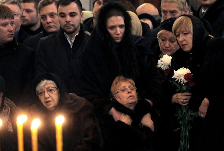 Image: Marina Karlova the widow of killed Russian ambassador to Turkey, Andrey Karlov, and his mother Maria are surrounded by mourners as they attend a memorial service at the Christ the Savior Cathedral, in Moscow, Russia, Dec.22.