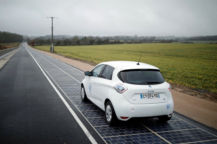 Image: An automobile drives on a solar panel road during its inauguration in Tourouvre