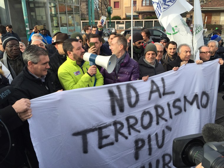 Image: Matteo Salvini, the leader of Italy's Northern League, stands behind a banner