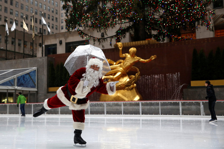 Image: A man dressed as Santa Claus ice skates at The Rink At Rockefeller Center on Christmas Eve in Manhattan, New York City, U.S.