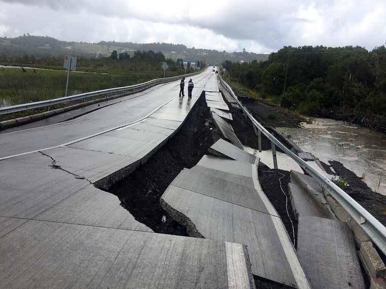 Image: A damaged road is seen after a quake at Tarahuin, on Chiloe island, southern Chile