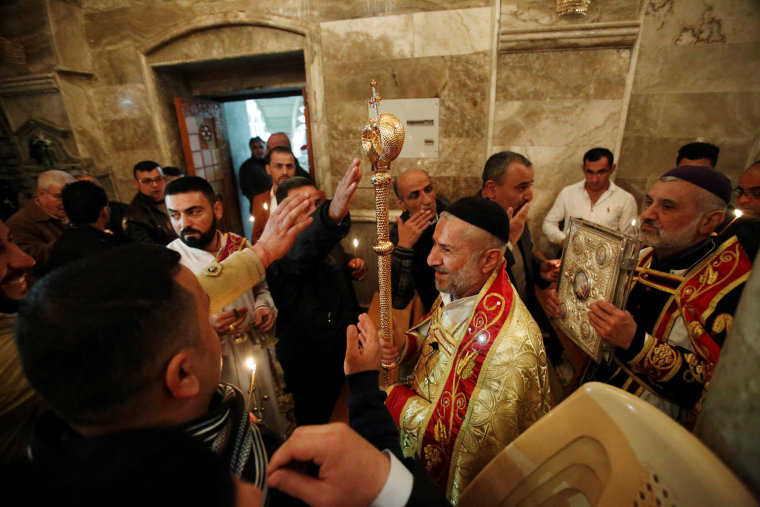 Image: Iraqi Christians attend a mass on Christmas at an Orthodox church in the town of Bashiqa